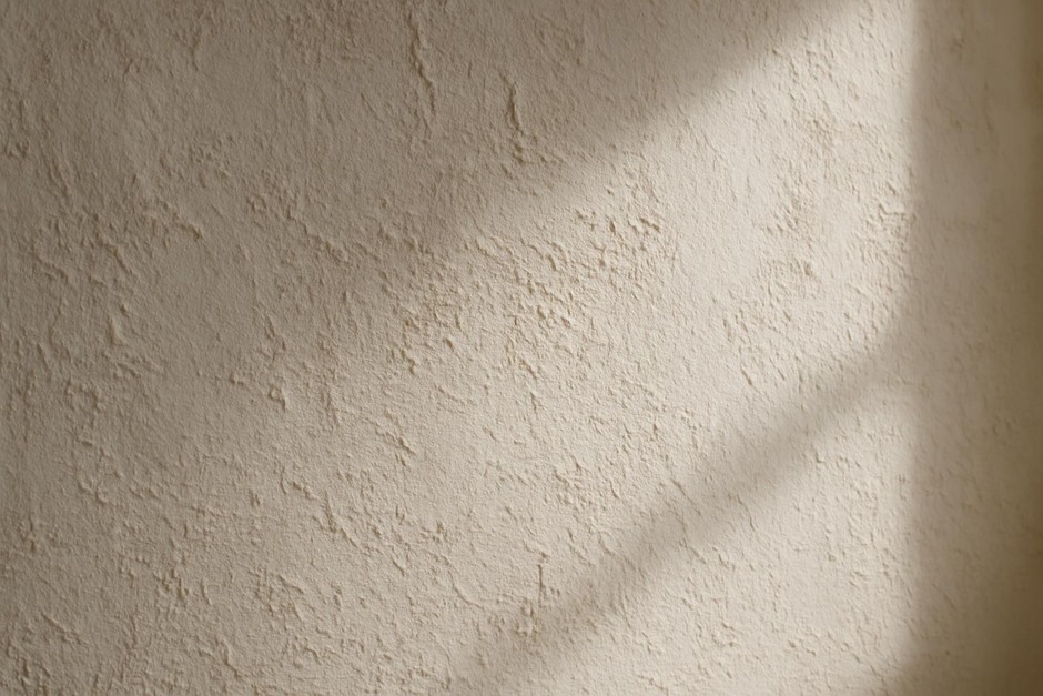 Close-up of textured wall lit by soft window light